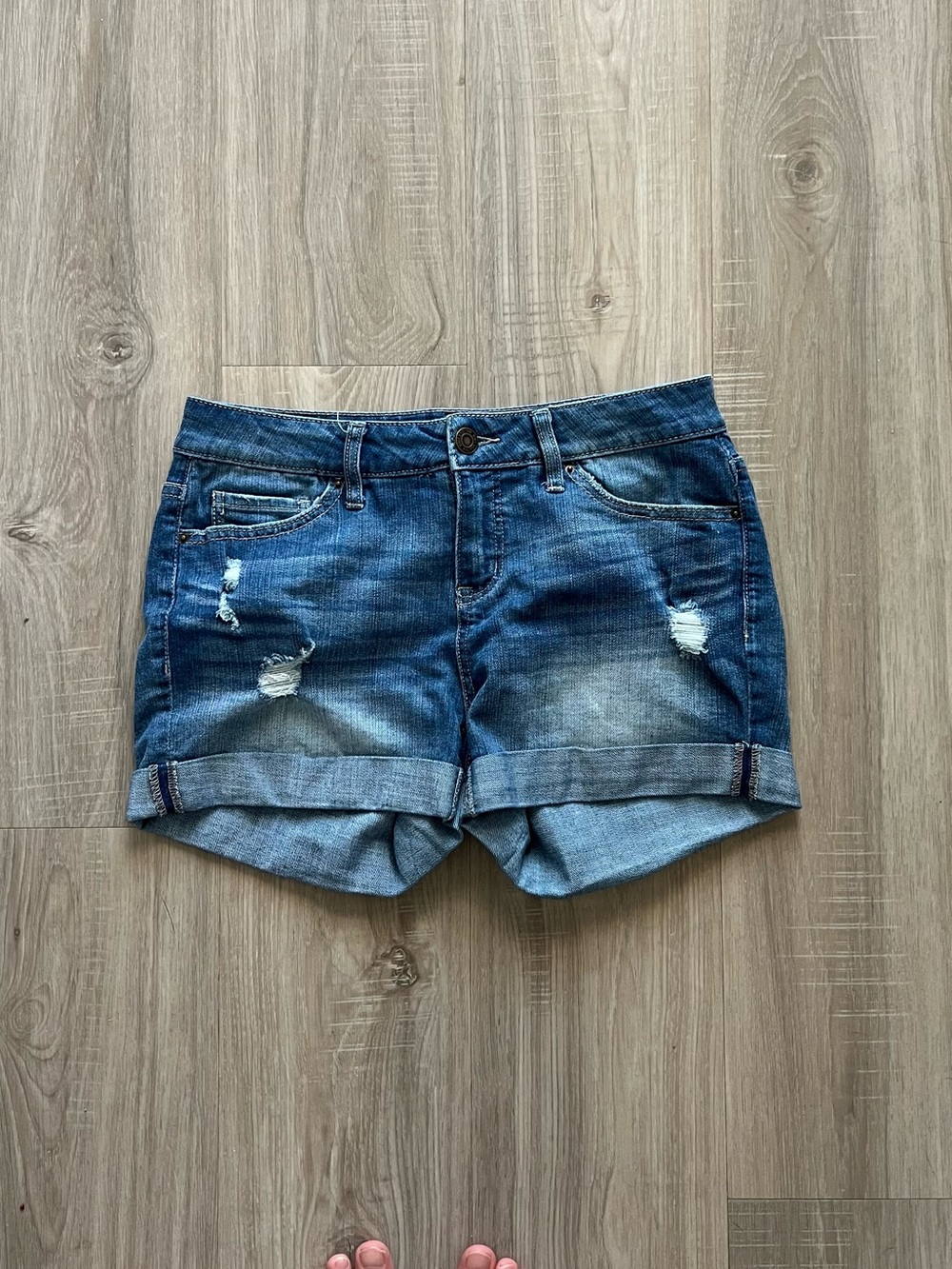 Blue denim jean shorts with distressed details